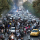 In this Sept. 21, 2022 photo taken by an individual not employed by the Associated Press and obtained by the AP outside Iran, protesters chant slogans during a protest over the death of a woman who was detained by the morality police in downtown Tehran, Iran.